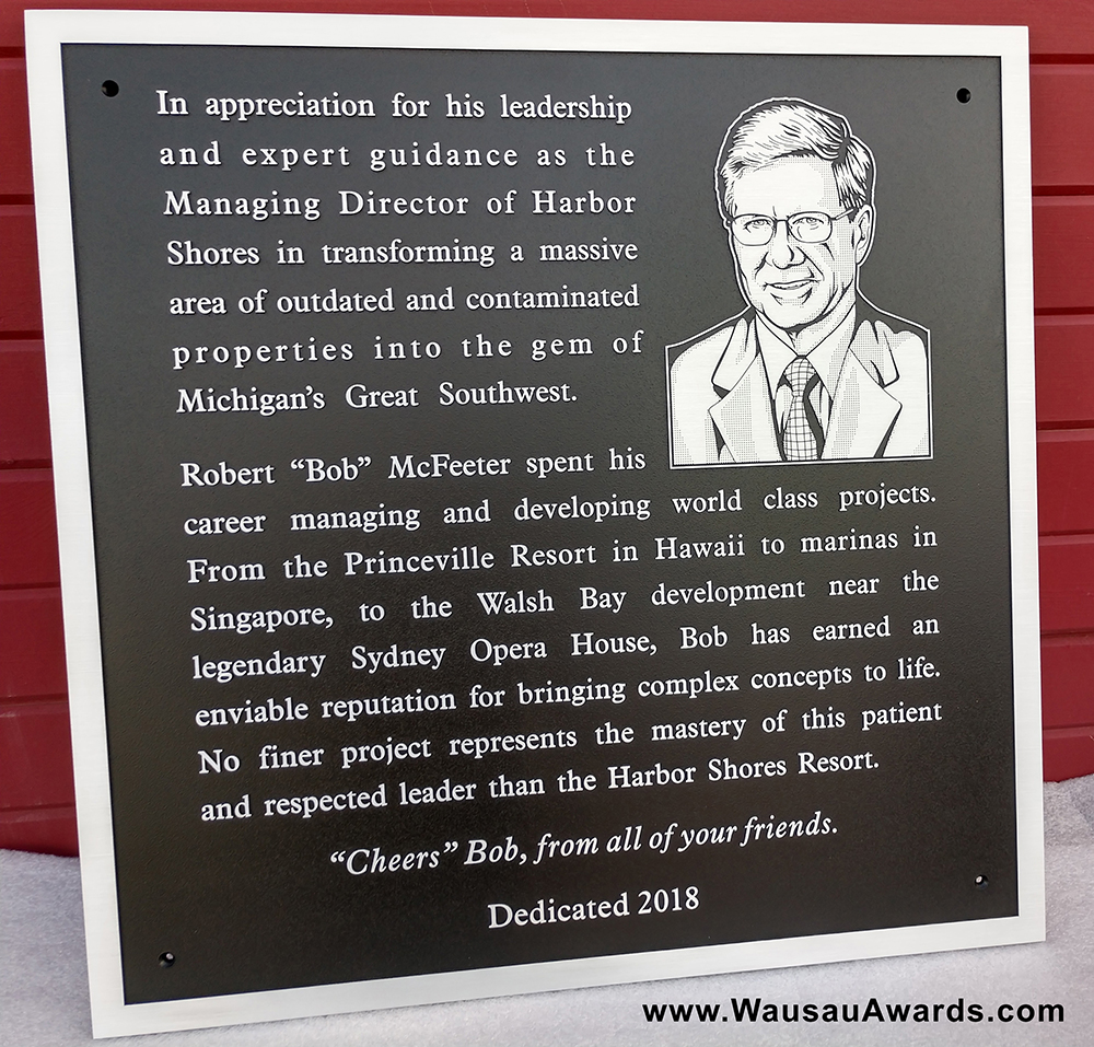 An aluminum dedication plaque with a flat relief photo incorporated into it